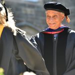 A graduate greets Tyler Stovall, Dean of the Graduate School of Arts and Science