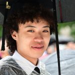 closeup of grad with cap in the rain