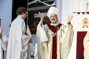 Cardinal at a Mass with arms raised