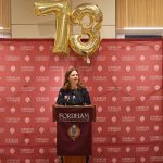 A woman speaks at a podium